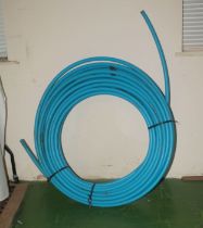 A roll of blue plastic water pipe