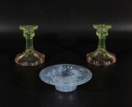 A pair of glass candlesticks and a bowl