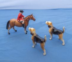 Two fox hounds and a pony and rider