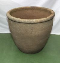 A large reconstituted stone garden planter 62cm dia. x 56cm tall