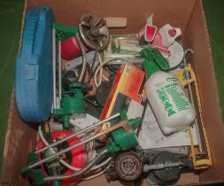 A box of assorted garden and camping equipment