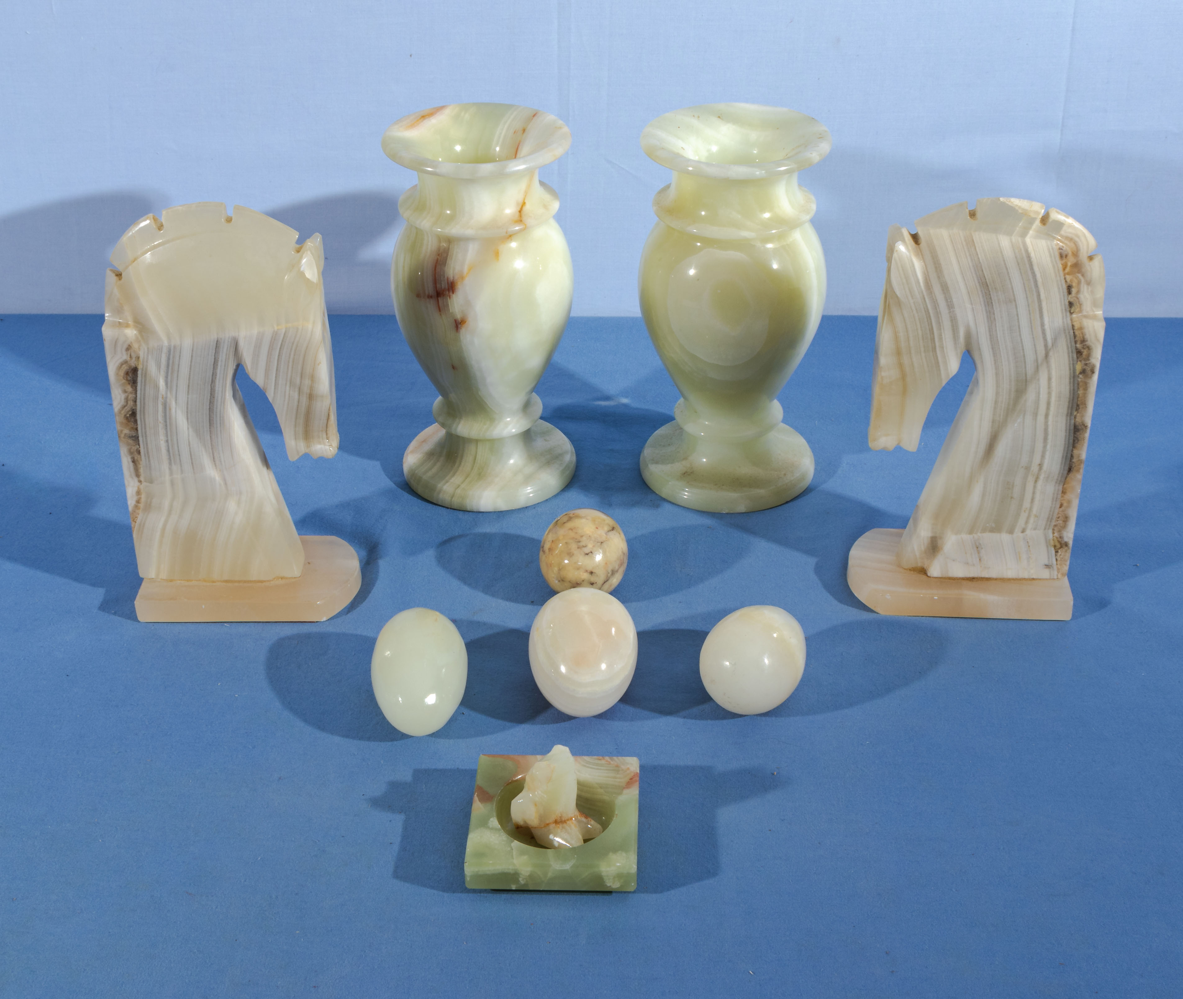 Pair of onyx vases, pair of bookends and eggs