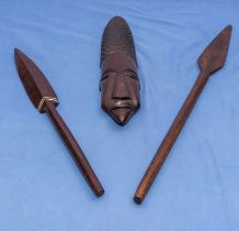 Two African carved hardwood spears and a wall mask