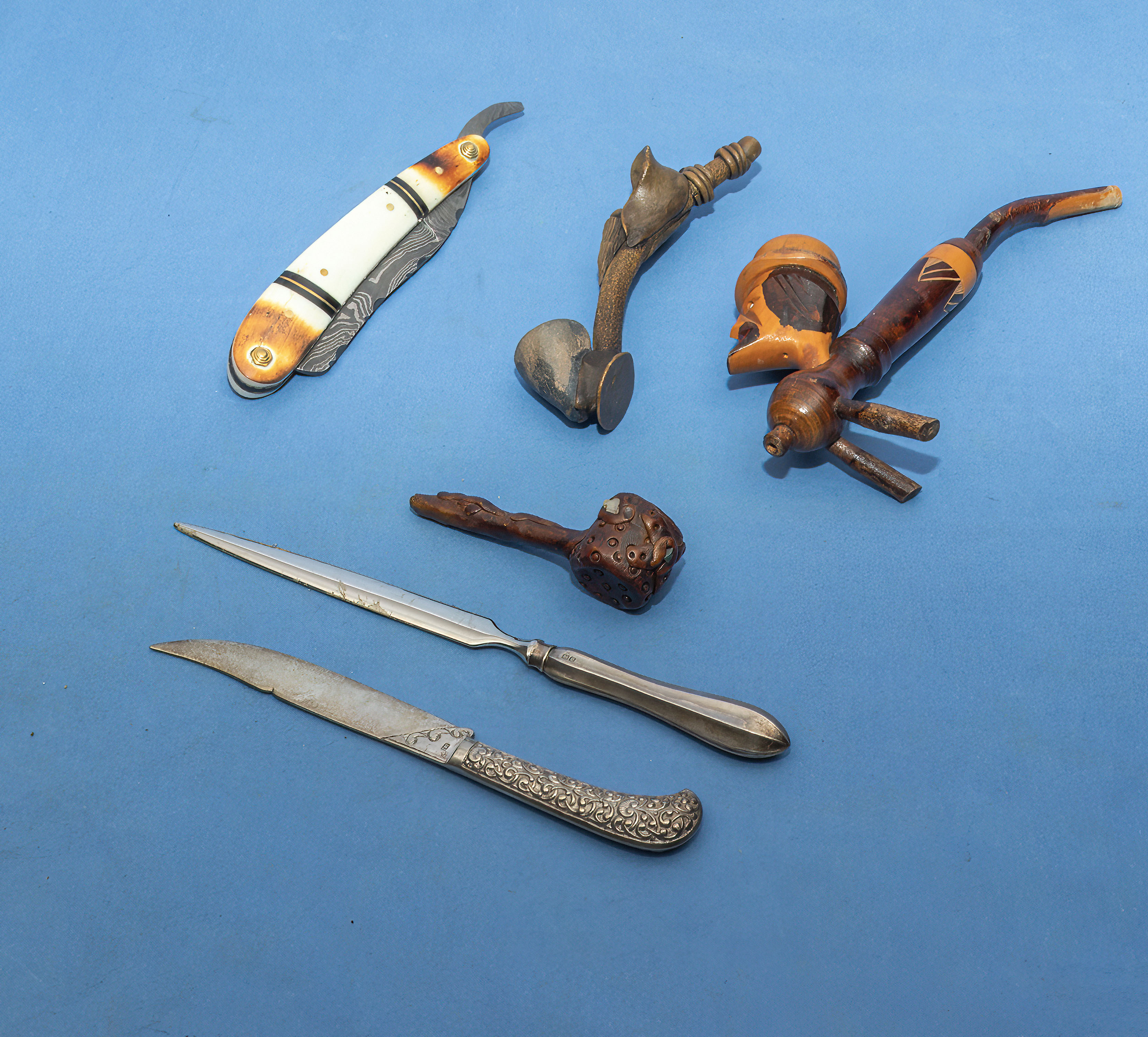 Two silver letter openers, three pipes and a divers knife