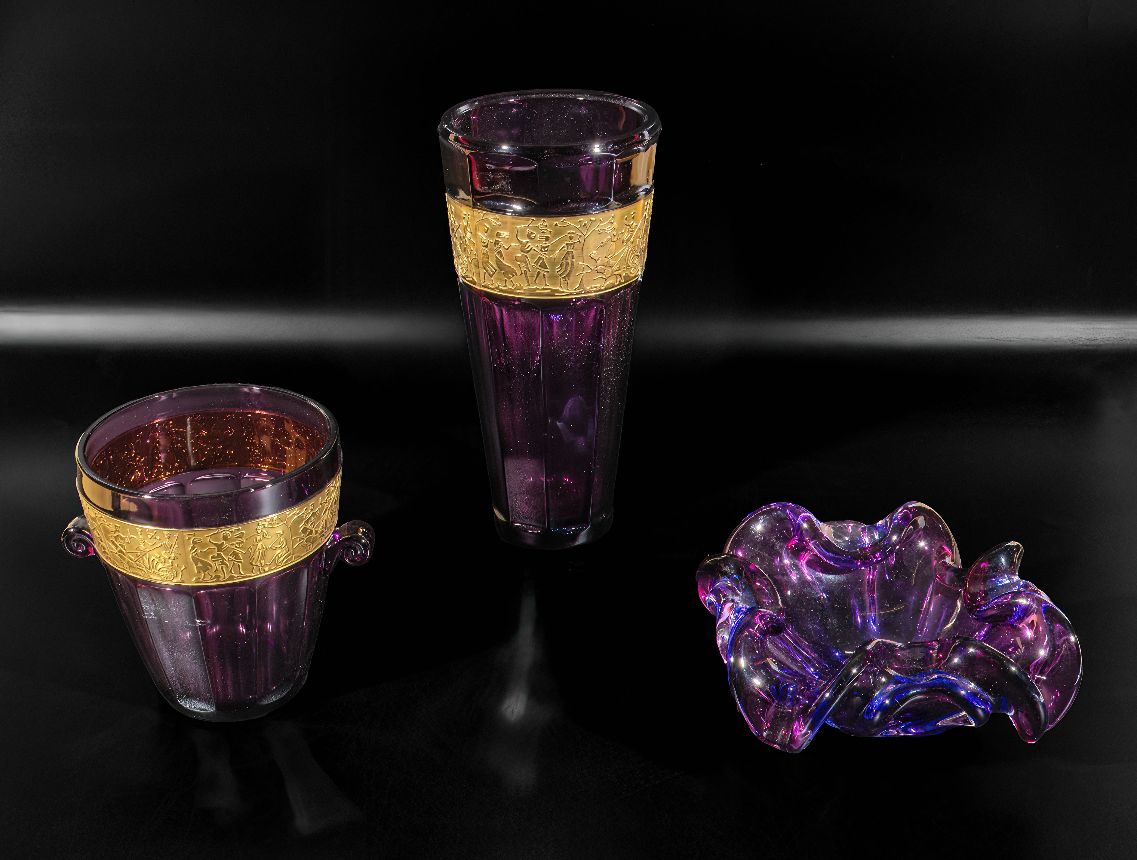 Two purple and gilt glass vases and one other