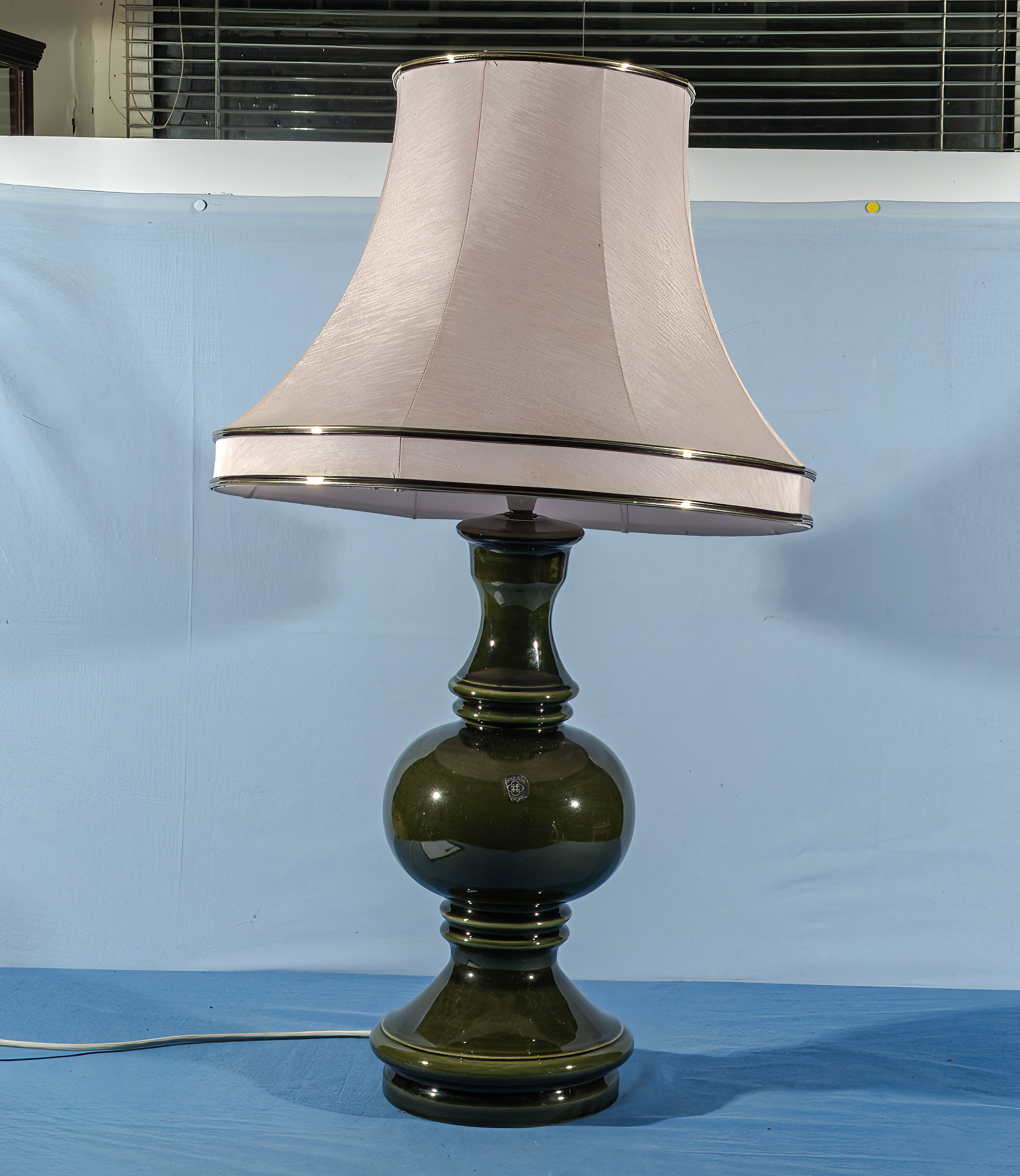 A large green Staffordshire Doulton table lamp and shade