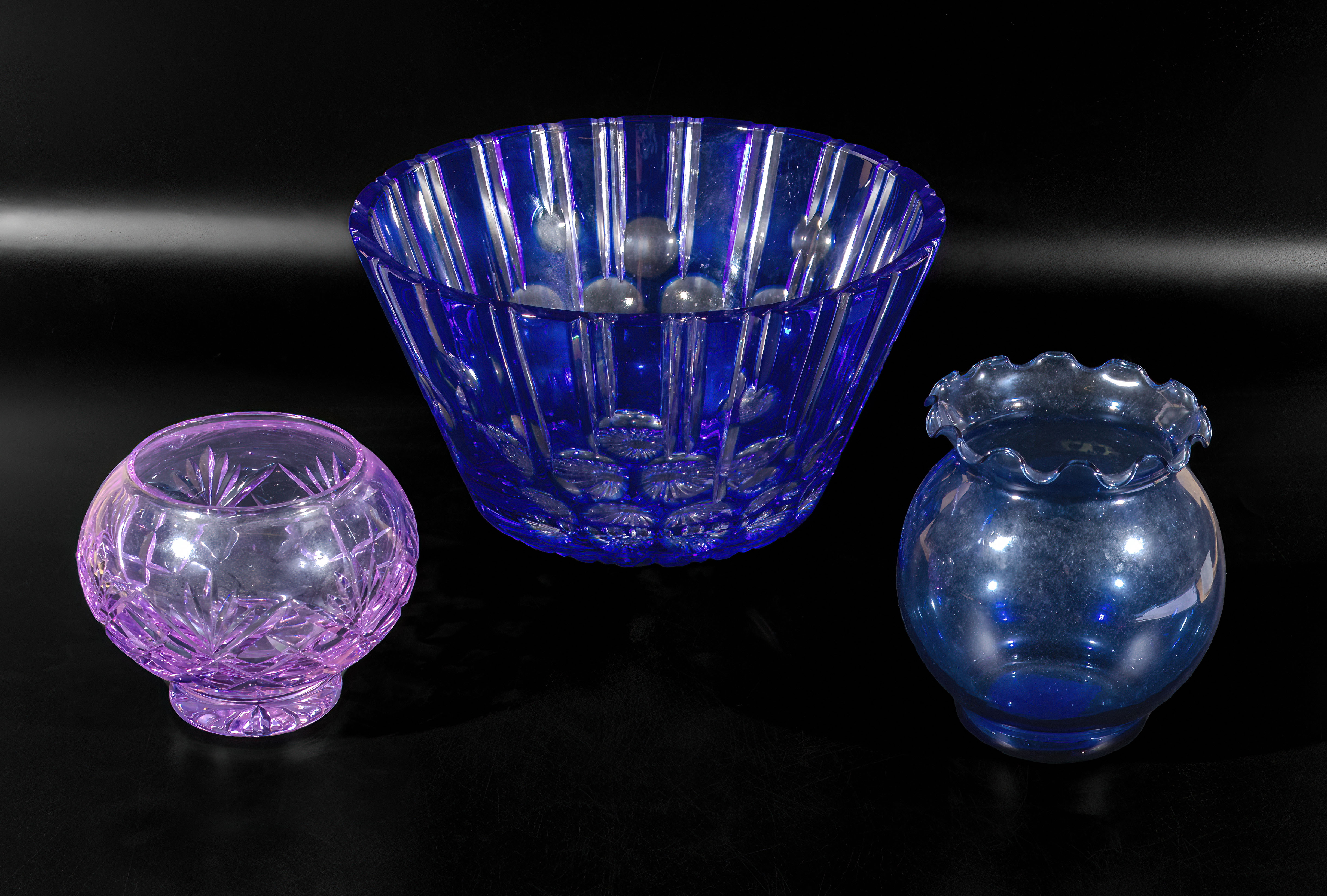 A blue glass fruit bowl and two others