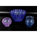 A blue glass fruit bowl and two others