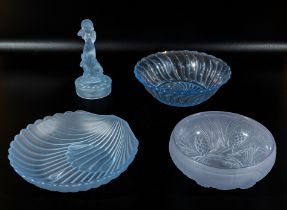 Four blue glass bowls and a figure