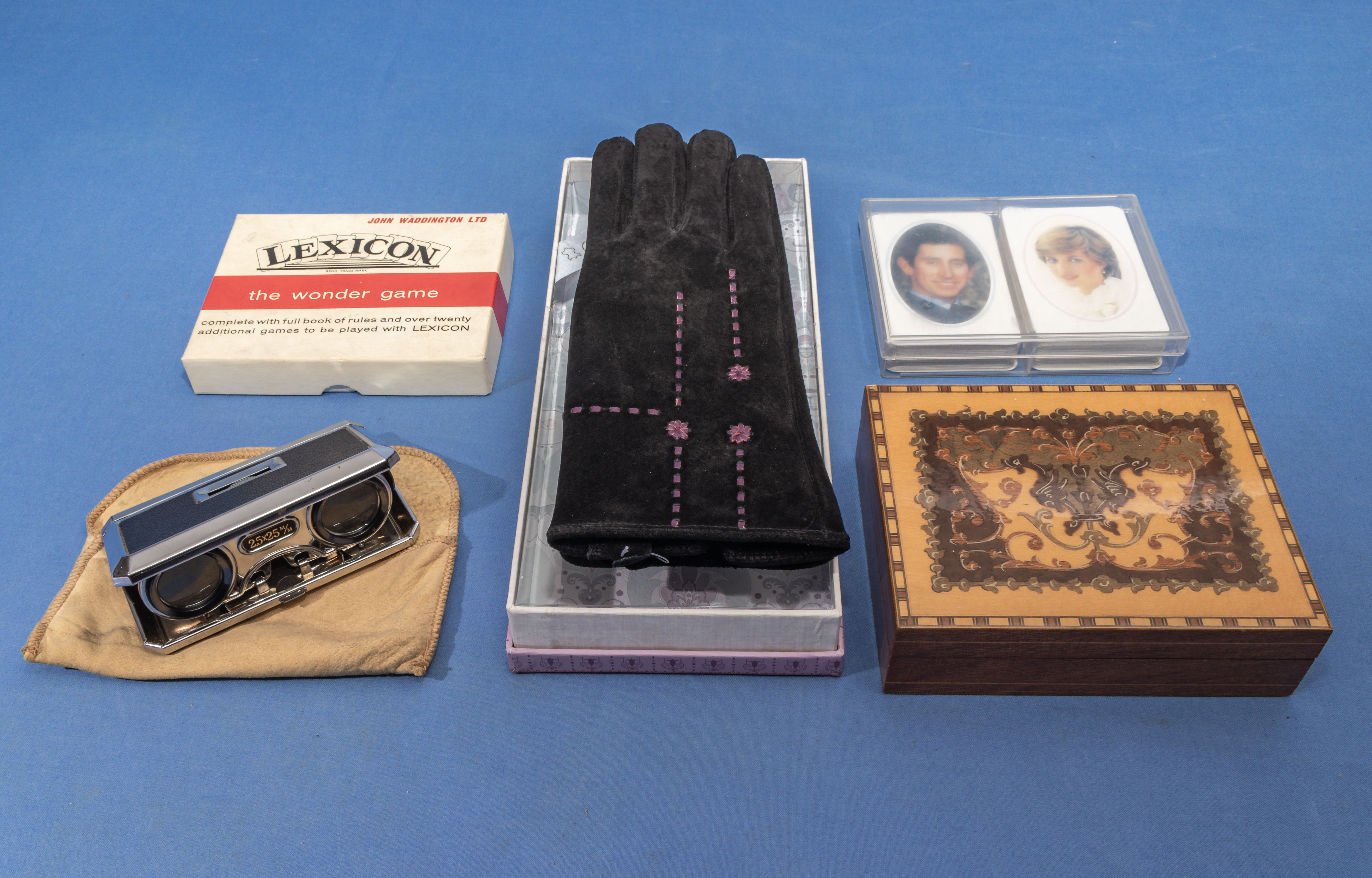 Pair of lady’s glove, opera glasses, two packs of cards and a box with bank notes