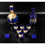 Blue and gilt carafe and six glasses together with one other and two candle holders