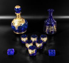 Blue and gilt carafe and six glasses together with one other and two candle holders