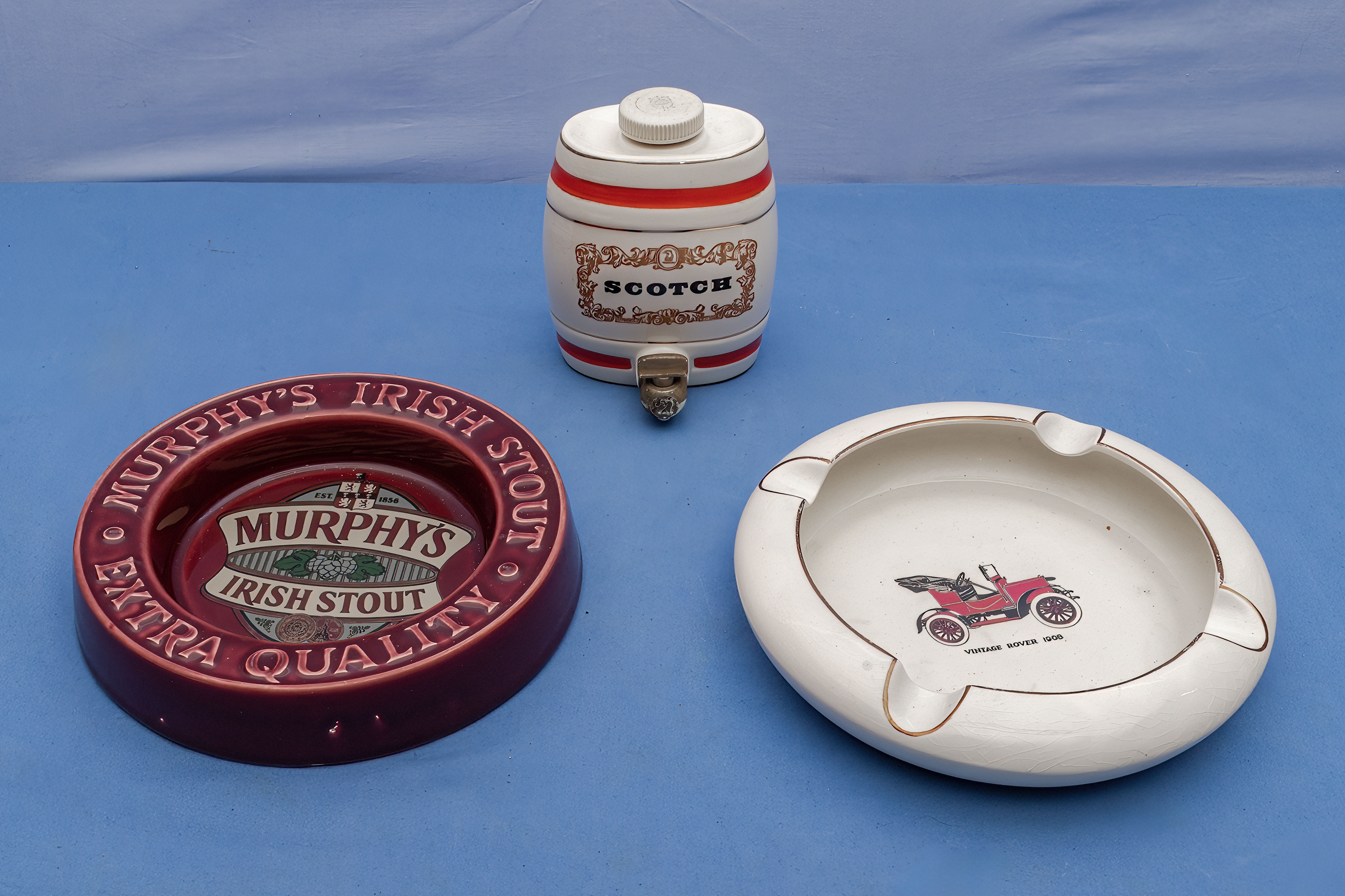Two vintage ashtrays and a Scotch barrel
