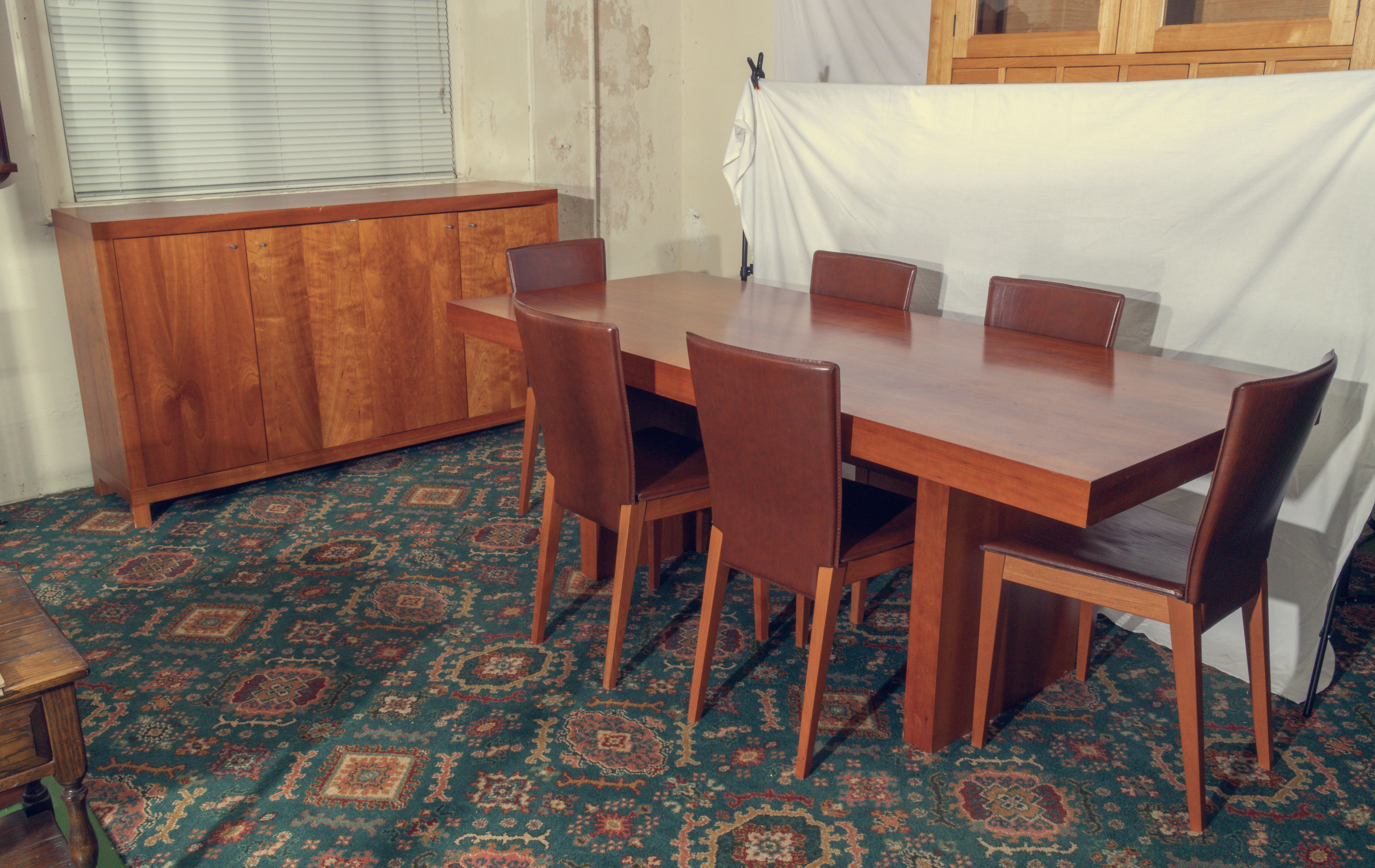 A 20th century contemporary dining table and six chairs together with matching sideboard.