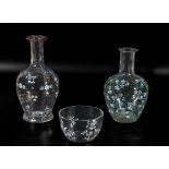 Two decorated glass carafes and a bowl
