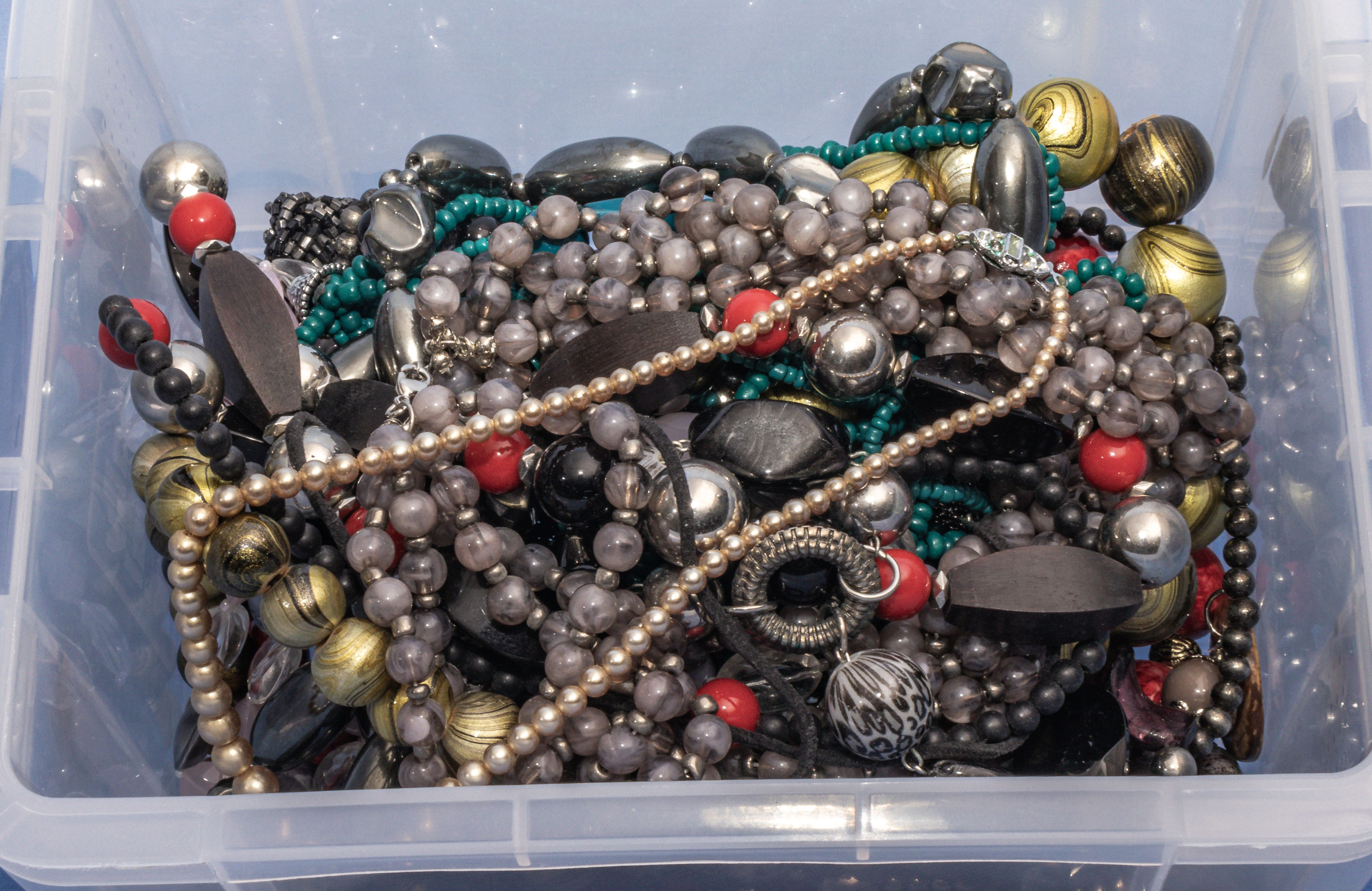 Box of vintage costume jewellery chains and necklaces