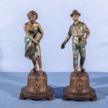 A pair of painted spelter figures 24cm tall
