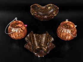 Four pieces of amber coloured glass