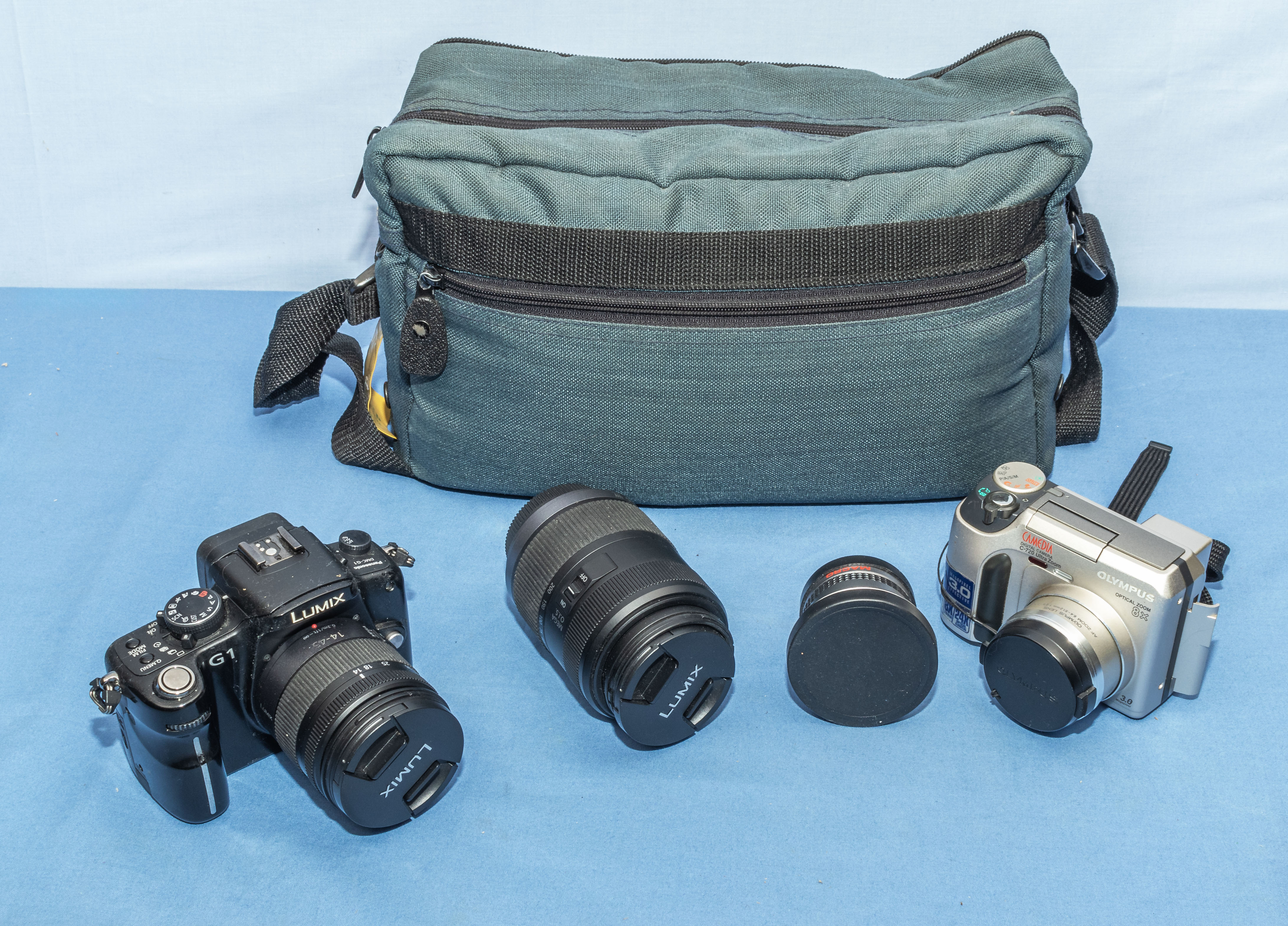 Lumix camera and an Olympus camera with two lens