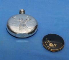 A hip flask and a powder compact