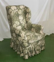 A wing backed armchair on cabriole legs with William Morris loose covers
