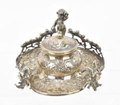 A Continental imported silver inkwell, mounted with a cherub, the two front feet with horned