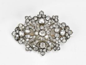 An Edwardian white metal diamond encrusted brooch, set with various sized old mine cut diamonds, the