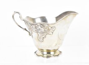 A Tiffany & Co sterling silver milk jug with acanthus scroll pattern detail, on a wave rim foot, the