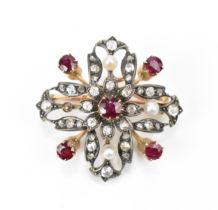 An Edwardian diamond and ruby encrusted brooch, set in rose metal and white metal, forming a