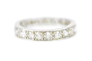 A white metal and diamond eternity ring, set with nineteen pave set round cut diamonds, size K 1/2-L