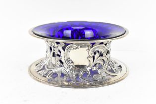 A George V silver dish ring by D & J Wellby Ltd, London 1913, with blue glass liner, the pierced
