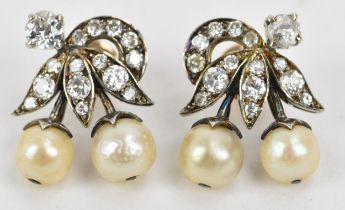 A pair of 1920s diamond and pearl set white metal earrings of flower design each having a