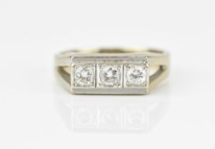 An 18ct white gold and three stone diamond dress ring,