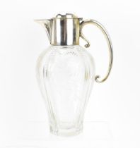 A Victorian silver-mounted cut glass claret jug by Hukin & Heath, London 1898, with hoop handle, the