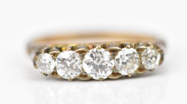 A yellow metal, and five stone diamond ring, set with graduated old cut diamonds, the central one