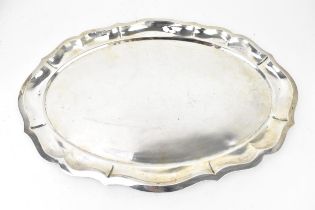 A Continental white metal platter, of oval form with pinched rim, 46.5 cm wide, weight 828 grams