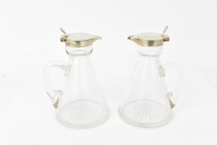 A pair of Edwardian silver mounted whisky tots by Hukin & Heath, Birmingham 1908, each with glass