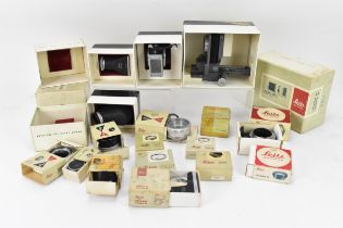 A collection of various Leitz camera equipment, comprising 16556 P / 16557 Q Leica M bellows, a