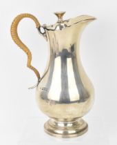 An Edwardian silver hot water jug by Mappin & Webb, London 1903, of baluster form with woven cane