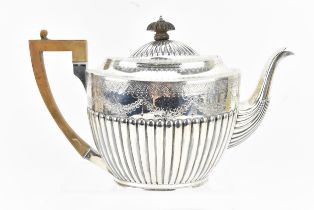 A Victorian silver teapot by Martin, Hall & Co, London 1890, with part fluted oval body with