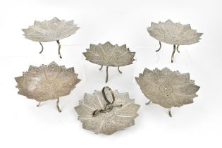 A set of six Oriental filigree white metal dishes, possibly Persian, the dishes in a floral form