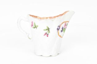 A Worcester painted cream jug, circa 1760, with painted floral sprays, gilt detail, moulded