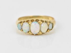 An 18ct yellow gold and five stone water opal ring, with graduated oval cabochon opals, size R 1/2