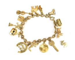 A 9ct gold charm bracelet, with various charms such as a violin, a camel, key, bull, shoe, Arc de