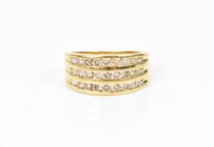 An 18ct yellow gold and diamond ring, set with three rows of channel set graduated brilliant cut