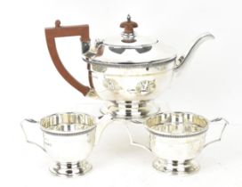 A George V silver three-piece tea set by Mappin & Webb, comprising a teapot, twin-handled sugar