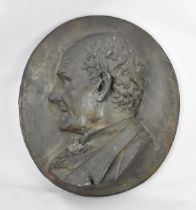 A late 19th century French cast metal relief profile of a gentleman, with artist's engraved