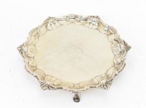 A George II silver waiter by Hugh Mills, London 1746, with shell and scroll moulded rim, on three