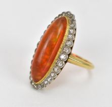 A yellow metal, diamond and fire opal dress ring, of navette form with cabochon oblong opal in a