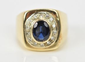 A yellow metal, diamond and blue sapphire gentlemen's signet style dress ring, with central oval cut